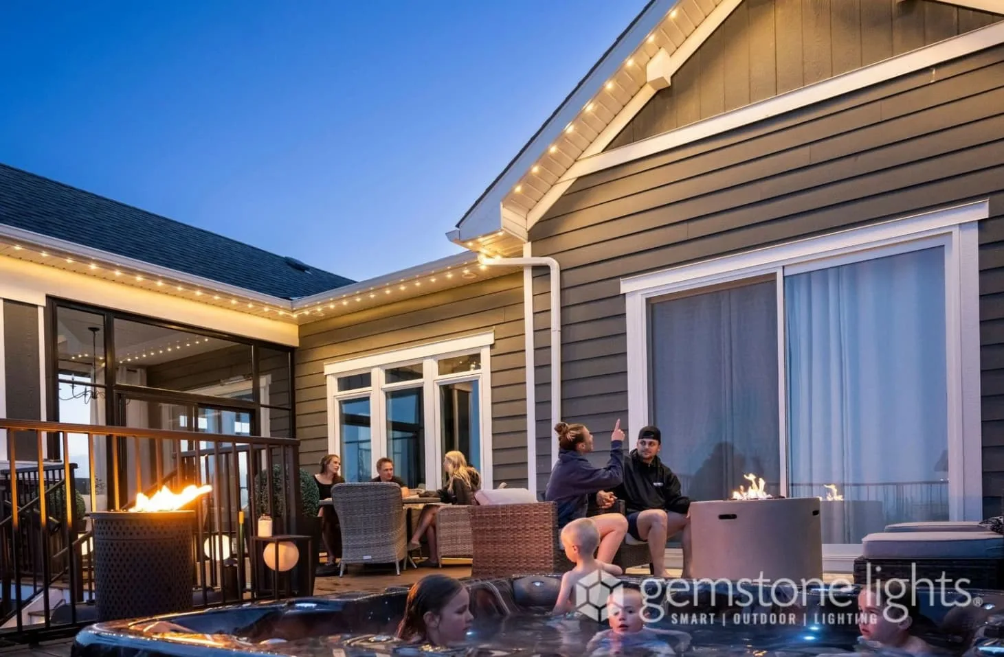 A cozy outdoor gathering features friends enjoying conversation by a hot tub and fire